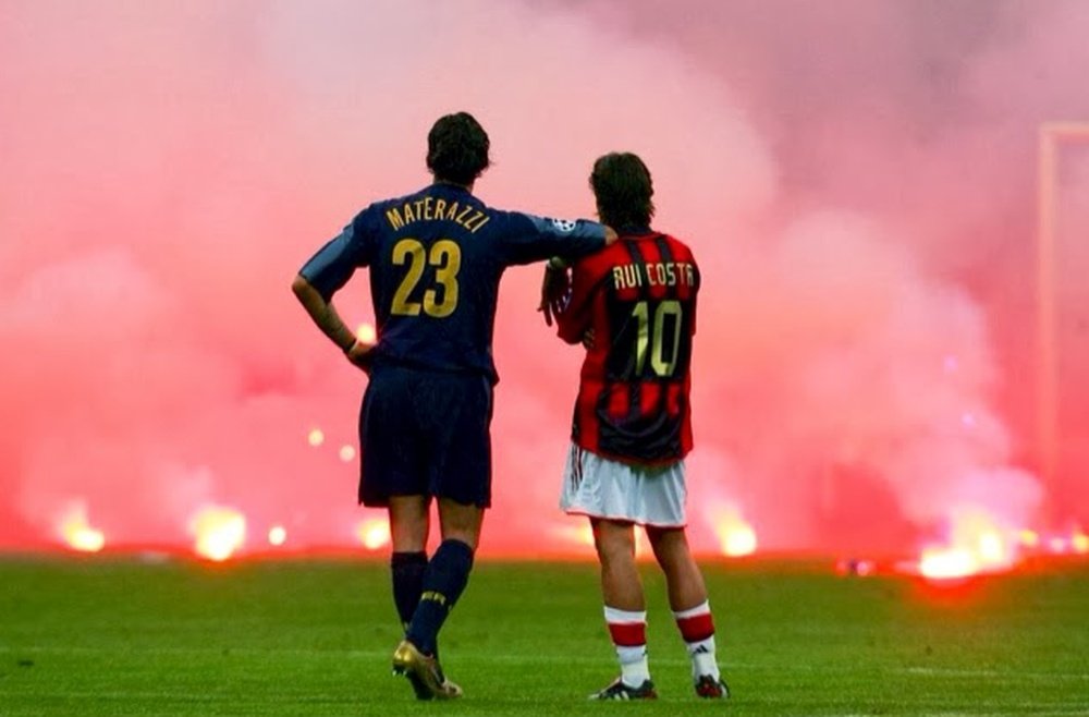 Materazzi (Inter Milan) and Rui Costa (AC Milan) gazing at the flares thrown by angry supporters at the San Siro, 2005 UCL Semi-final